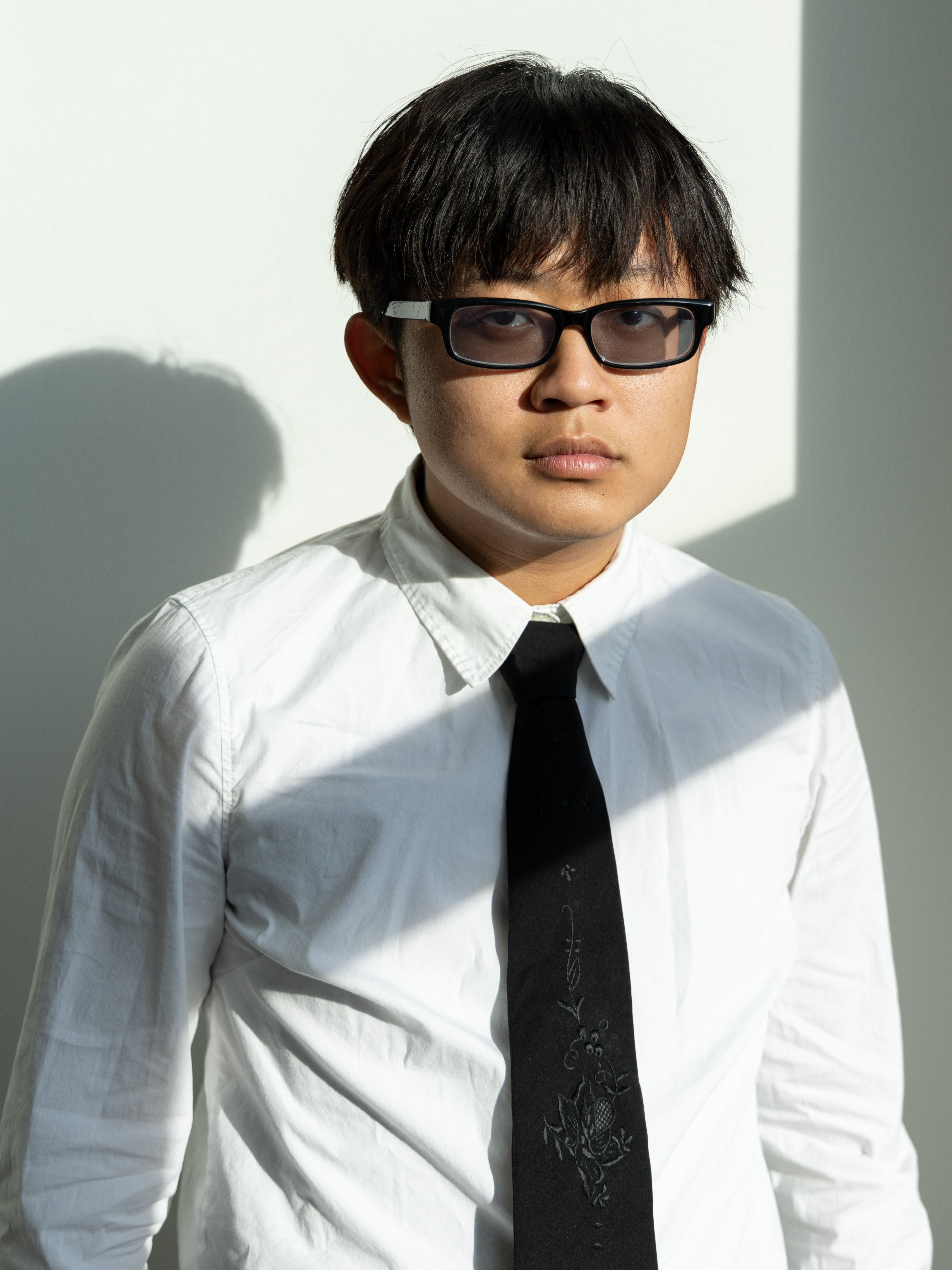 Li Fan standing in front of a wall.